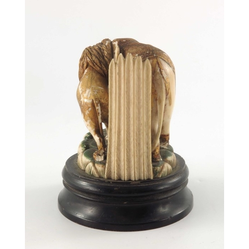 435 - ? A 19th century carved and painted ivory figure group, modelled as a lion attacking an elephant gil... 