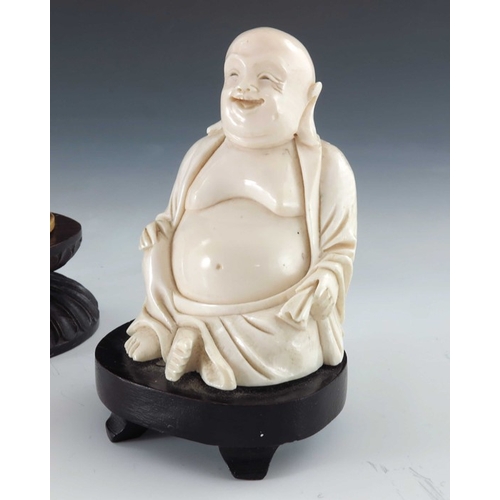 435a - ? A 19th century carved seated ivory figure, modelled as Buddha, together with a carved ivory figure... 