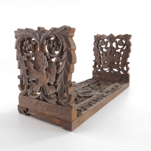 453 - A 19th century Anglo Indian carved rosewood book slide, reticulated foliate carved ends with paisley... 