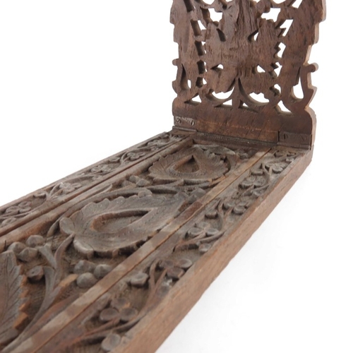 453 - A 19th century Anglo Indian carved rosewood book slide, reticulated foliate carved ends with paisley... 