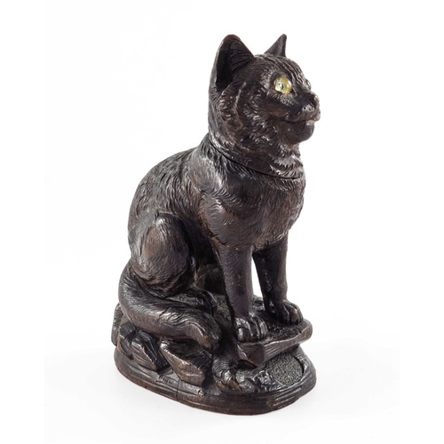 469 - A Black Forest carved wooden inkwell, 19th century, modelled as a cat, set with glass eyes, 18cm hig... 