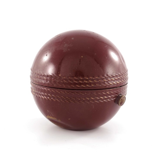 476 - A novelty travel beaker set in the form of a cricket ball, circa 1950s, enamelled and gilded to the ... 