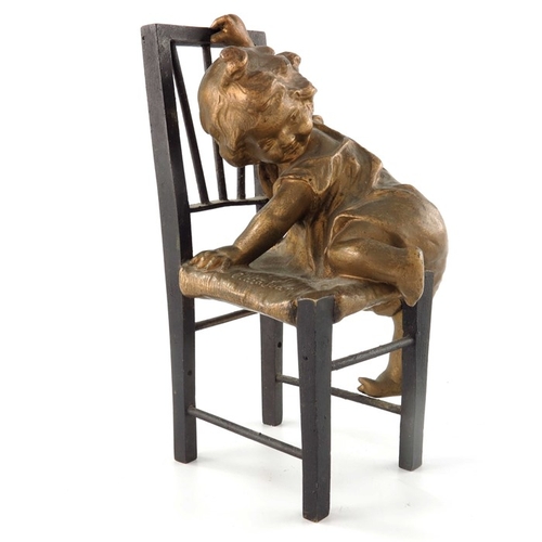 482 - Juan Clara (1857-1958), a bronze and gilt sculpture, modelled as a child climbing on a chair, signed... 