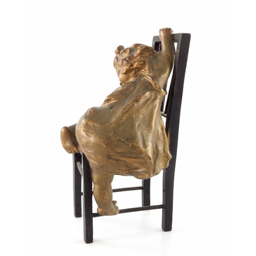 482 - Juan Clara (1857-1958), a bronze and gilt sculpture, modelled as a child climbing on a chair, signed... 