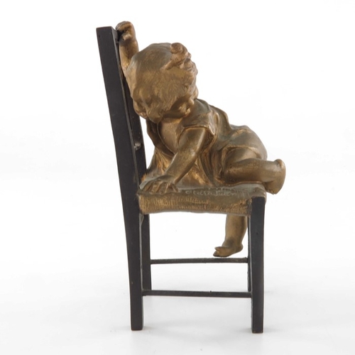 482 - Juan Clara (1857-1958), a bronze and gilt sculpture, modelled as a child climbing on a chair, signed... 