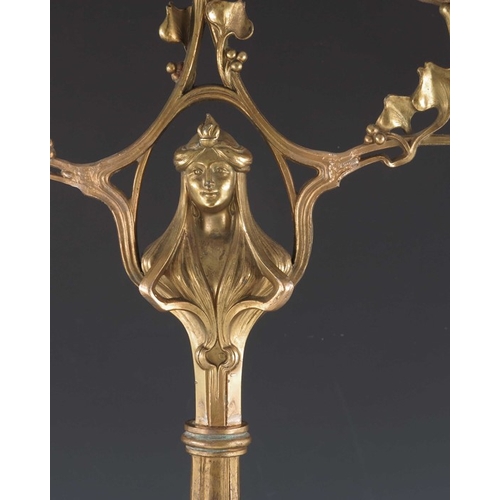 505 - A Jugendstil gilt metal three light candelabrum, Art Nouveau style, cast foliate and open tendril de... 