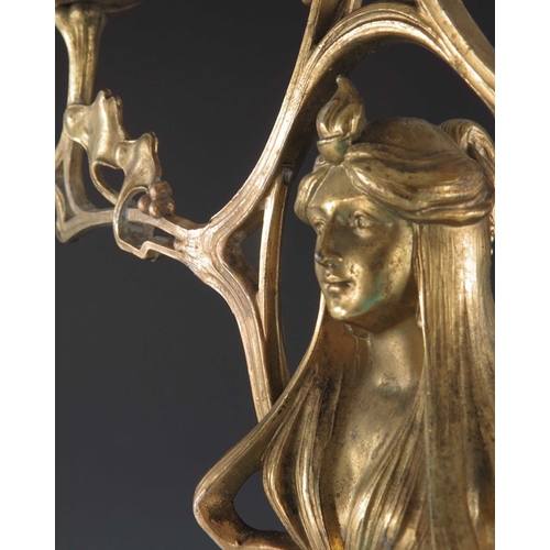 505 - A Jugendstil gilt metal three light candelabrum, Art Nouveau style, cast foliate and open tendril de... 