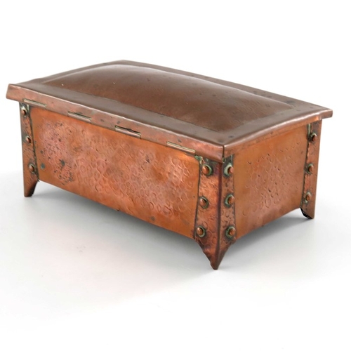 514 - An Arts and Crafts copper box, cuboid form, planished with riveted strap legs, 17.5cm wide, 8cm high... 