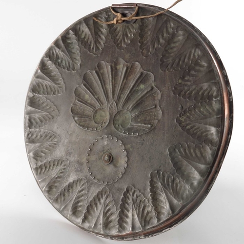 515 - An Arts and Crafts copper and brass wall sconce, circular tray form repousse embossed with scallop s... 