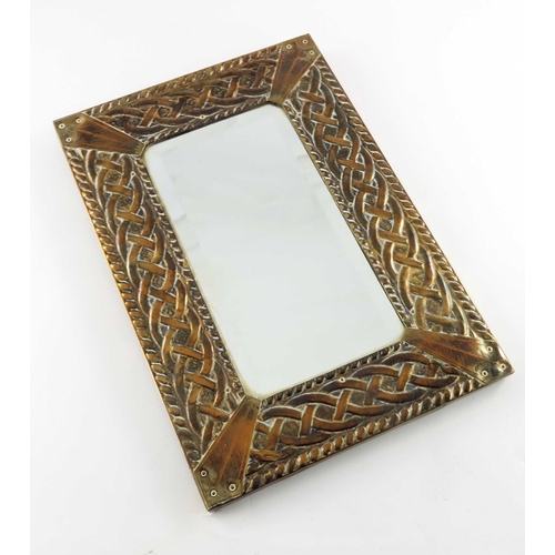 517 - An Arts and Crafts brass mirror, in the Glasgow style, Celtic knot within ropetwist borders, bevelle... 