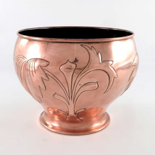 521 - An Arts and Crafts copper jardiniere, ogee form, repousse embossed with stylised leaf and foliate st... 