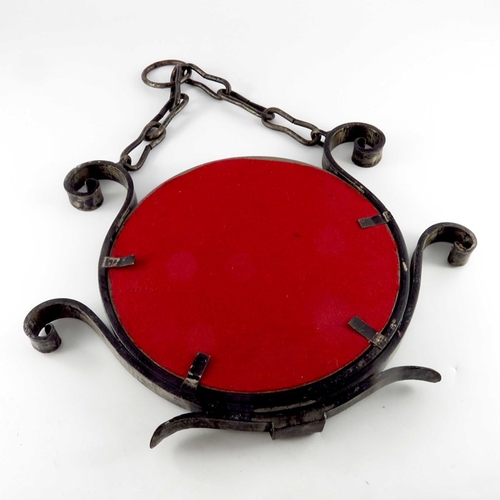 526 - Raymond Subes (attributed), an Art Deco wrought iron mirror, circa 1920s, the circular glass within ... 