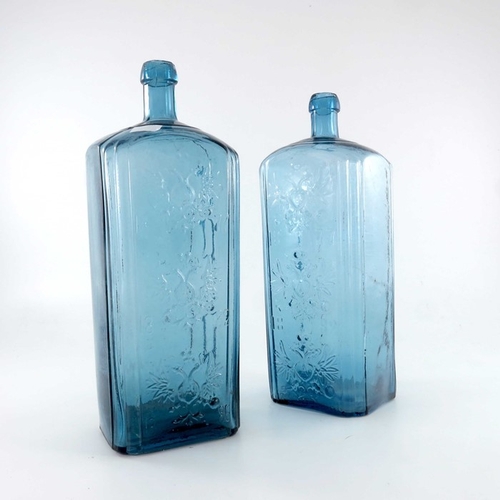 536 - Two Imperial Russian blue glass Smirnov vodka bottles, circa 1886, relief moulded with Imperial coat... 