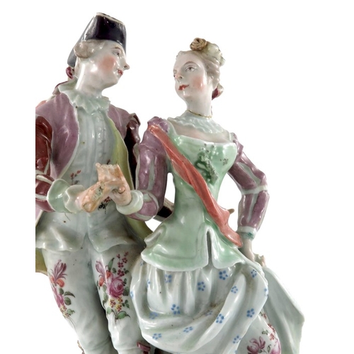 584 - A Continental porcelain figure group, 18th century, modelled as a courting couple, on scroll bracket... 