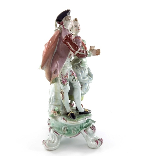 584 - A Continental porcelain figure group, 18th century, modelled as a courting couple, on scroll bracket... 