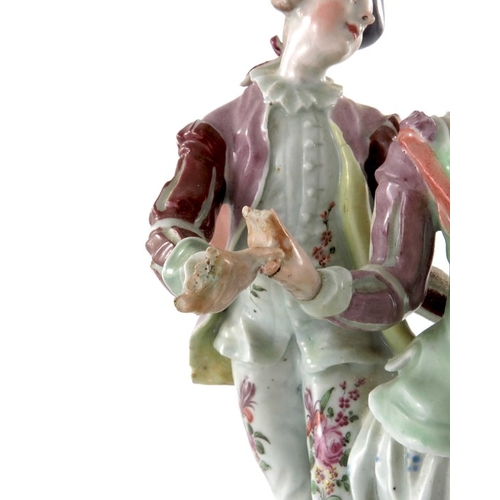 584 - A Continental porcelain figure group, 18th century, modelled as a courting couple, on scroll bracket... 