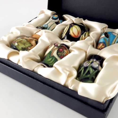 629 - A boxed set of six Moorcroft miniature vases, various designs and shapes, circa 2005, including ging... 