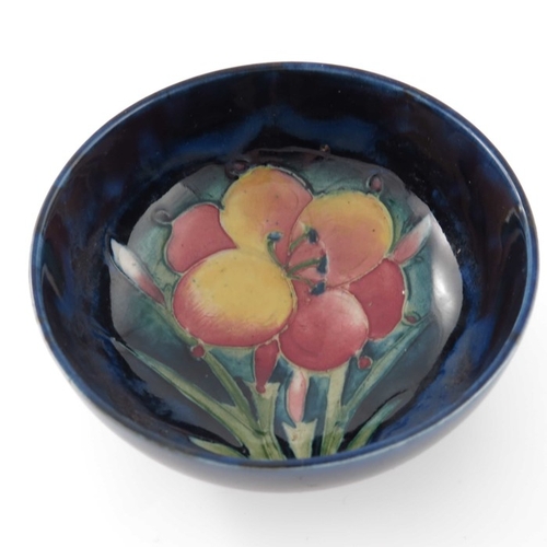 631 - Walter Moorcroft, an African Lily bowl, circa 1953, rounded and footed, impressed marks and facsimil... 