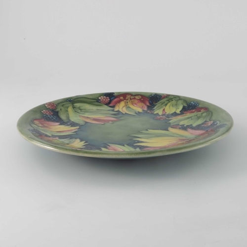 632 - William Moorcroft, a Leaf and Blackberry plate, circa 1930, circular with everted rim, impressed mar... 