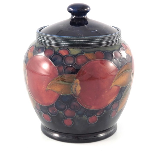 634 - William Moorcroft, a Pomegranate pot and cover, circa 1920, ovoid form, impressed marks and undergla... 