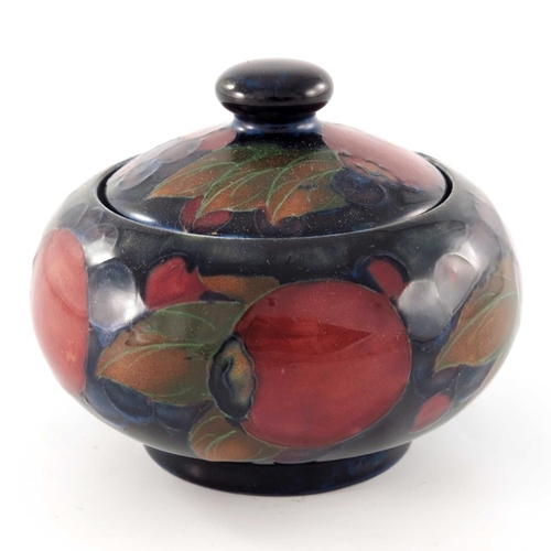 638 - William Moorcroft, a Pomegranate jar and cover, circa 1920, ovoid form, impressed marks and undergla... 