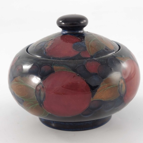 638 - William Moorcroft, a Pomegranate jar and cover, circa 1920, ovoid form, impressed marks and undergla... 