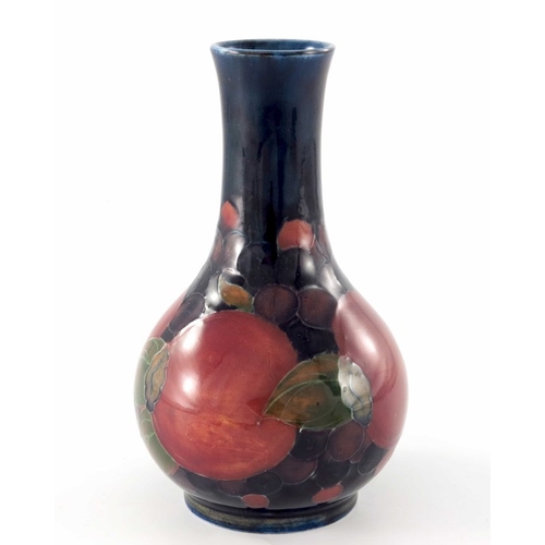 639 - William Moorcroft, a Pomegranate vase, circa 1920, bulbous bottle form, impressed marks and undergla... 