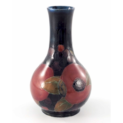 639 - William Moorcroft, a Pomegranate vase, circa 1920, bulbous bottle form, impressed marks and undergla... 