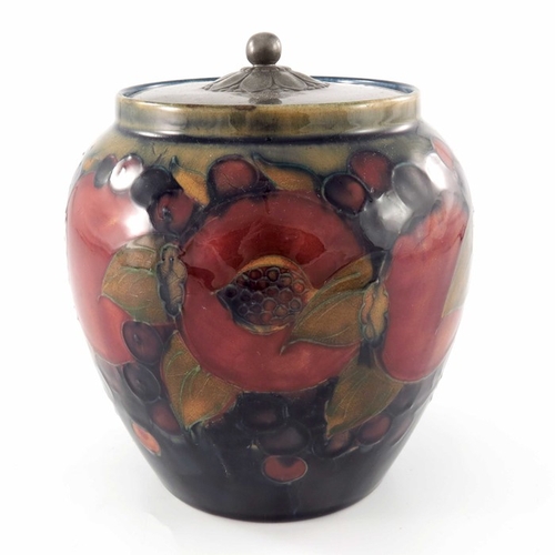 641 - William Moorcroft, a Pomegranate on ochre and blue jar with pewter cover, circa 1920, ovoid form, th... 