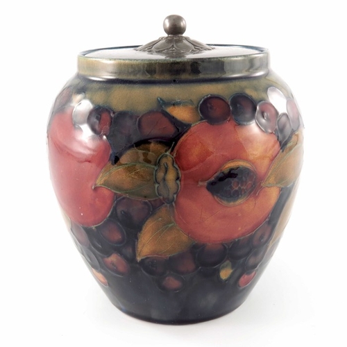 641 - William Moorcroft, a Pomegranate on ochre and blue jar with pewter cover, circa 1920, ovoid form, th... 