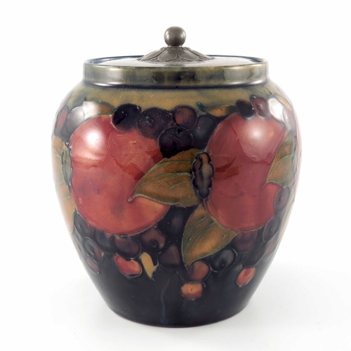 641 - William Moorcroft, a Pomegranate on ochre and blue jar with pewter cover, circa 1920, ovoid form, th... 