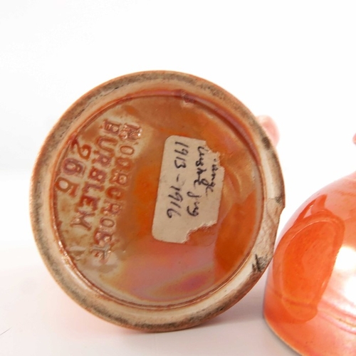 644 - William Moorcroft, a miniature orange lustre bowl and jug, circa 1914, footed rounded and conical fo... 