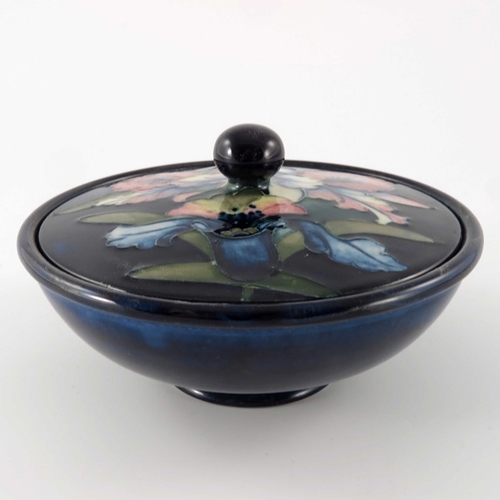 649 - William Moorcroft, an Orchid bowl and cover, circa 1935, squat form with flat cover, spherical knop,... 