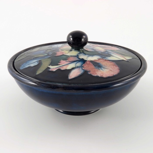 649 - William Moorcroft, an Orchid bowl and cover, circa 1935, squat form with flat cover, spherical knop,... 