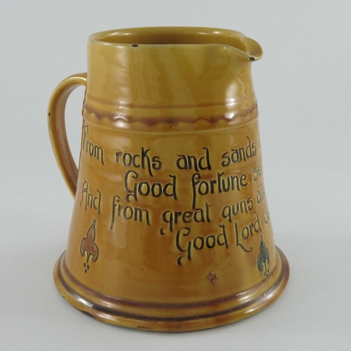 653 - C H Brannam for Liberty and Co., an art pottery motto jug, circa 1915, treacle glazed conical form, ... 