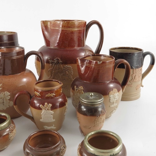 659 - A collection of Royal Doulton and Lambeth stoneware sprigged ware, including hunting jugs and mugs, ... 