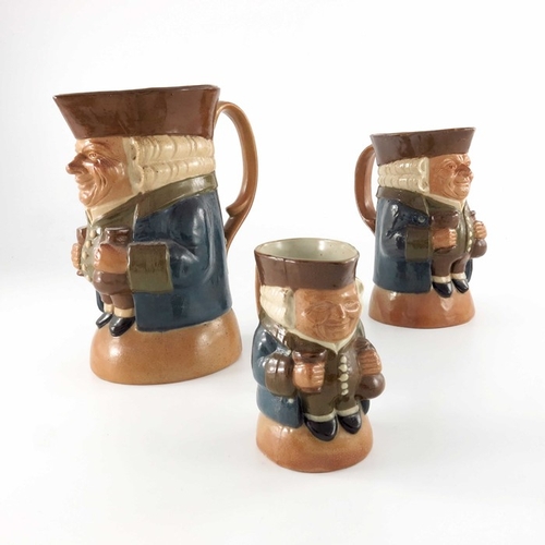 668 - Harry Simeon for Doulton Lambeth, a graduated set of three Toby jugs, each modelled with bottle and ... 