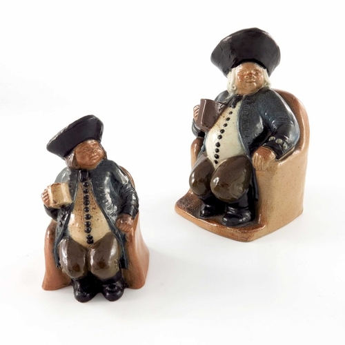 675 - Harry Simeon for Doulton Lambeth, a graduated pair of stoneware ash pots, modelled as seated Toby in... 