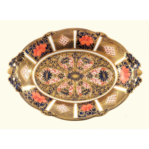 706 - A pair of graduated Royal Crown Derby Imari 1128 oval dishes, twin handles, on four pierced acorn an... 