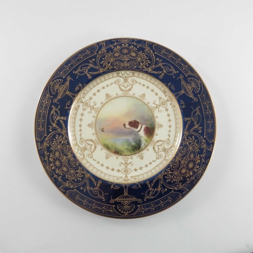 734 - A Royal Worcester painted cabinet plate, 1934, the central roundel decorated with a hunting dog and ... 