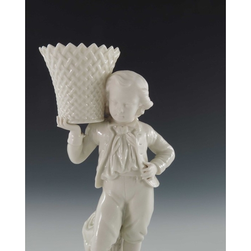 764 - A Belleek first period bisque and glazed porcelain figural spill vase, modelled as a boy holding a b... 