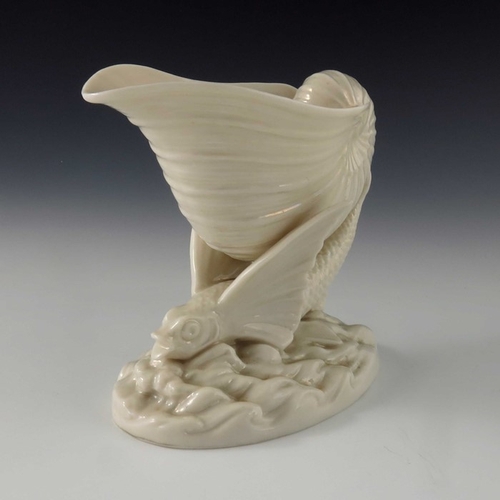 765 - A Belleek first period Flying Fish vase, pearlescent glaze, modelled as a winged fish with conch she... 