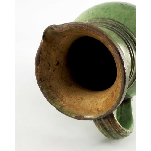 771 - A 19th century green glazed earthenware jug, possibly Farnham, ovoid form, incised to the shoulder w... 