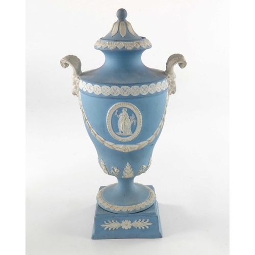 775 - Two Wedgwood Jasperware urn vases and covers, late 19th century, twin handled, one white on blue, og... 