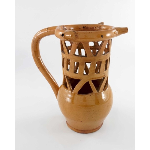 783 - A lead glazed puzzle jug, 18th or 19th century, bulbous form with reticulated lattice neck and hoop ... 