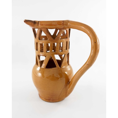 783 - A lead glazed puzzle jug, 18th or 19th century, bulbous form with reticulated lattice neck and hoop ... 