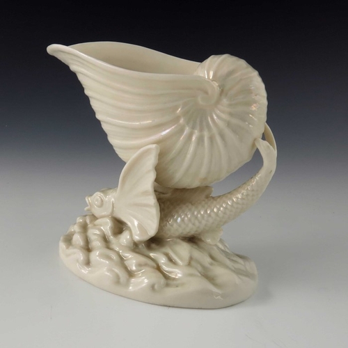 765 - A Belleek first period Flying Fish vase, pearlescent glaze, modelled as a winged fish with conch she... 