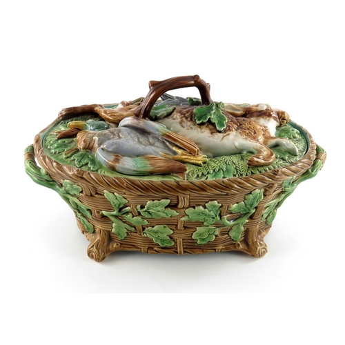 796 - A Minton majolica game pie dish and cover, circa 1875, the lid modelled as game resting on ferns and... 