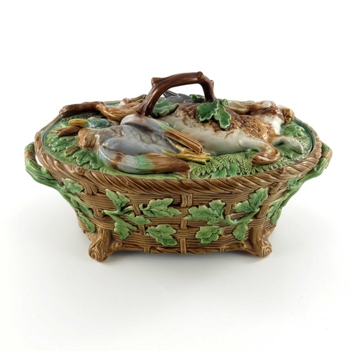 796 - A Minton majolica game pie dish and cover, circa 1875, the lid modelled as game resting on ferns and... 