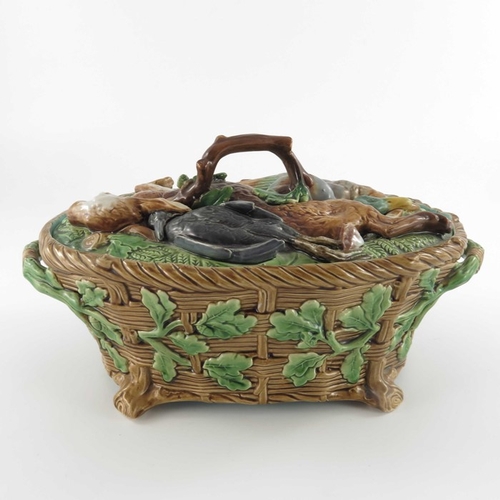 796 - A Minton majolica game pie dish and cover, circa 1875, the lid modelled as game resting on ferns and... 